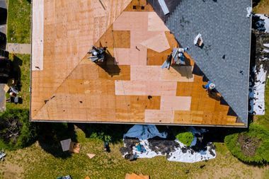 An aerial view of a roof being installed on a house.