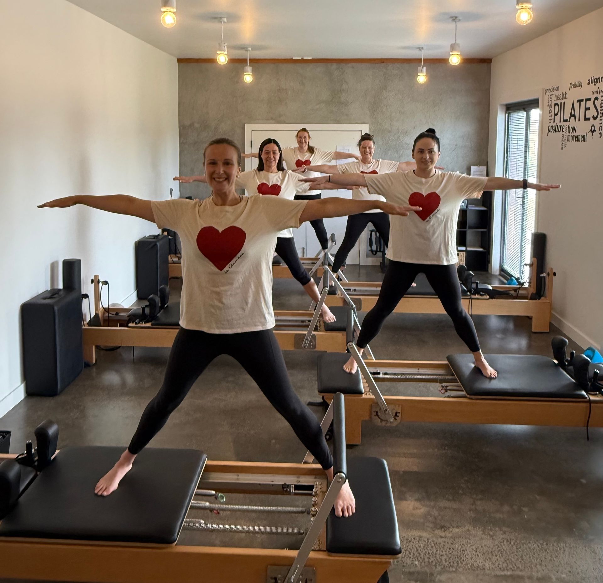 Two pilates machines are sitting in a room next to each other.