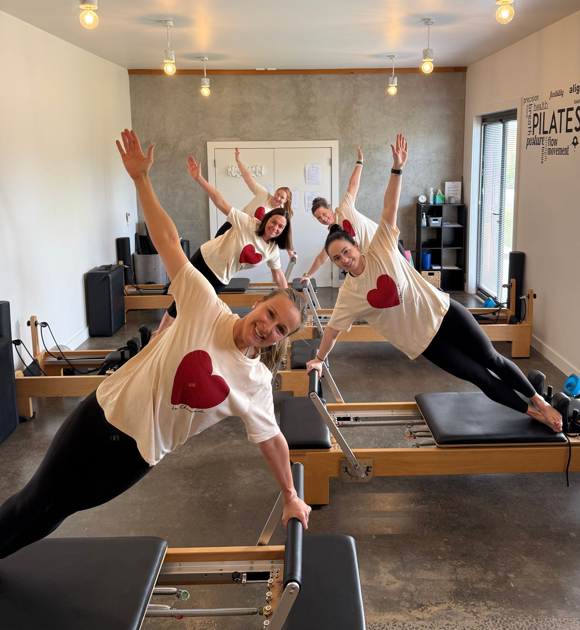 A group of women are doing pilates exercises in a gym.