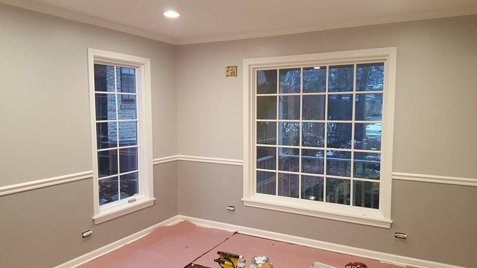 A room with two windows and a pink carpet.