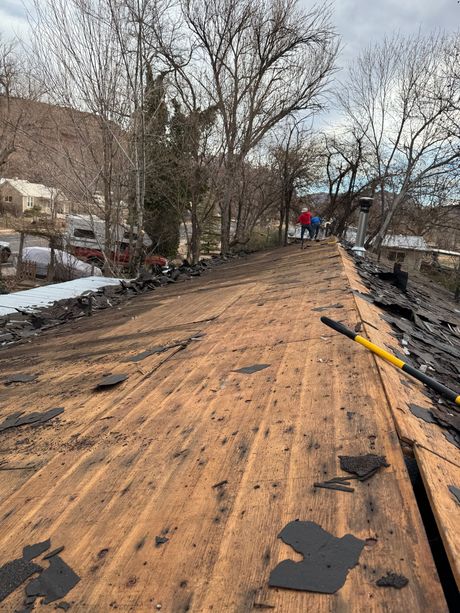 A wooden deck with a hammer and a shovel on it.