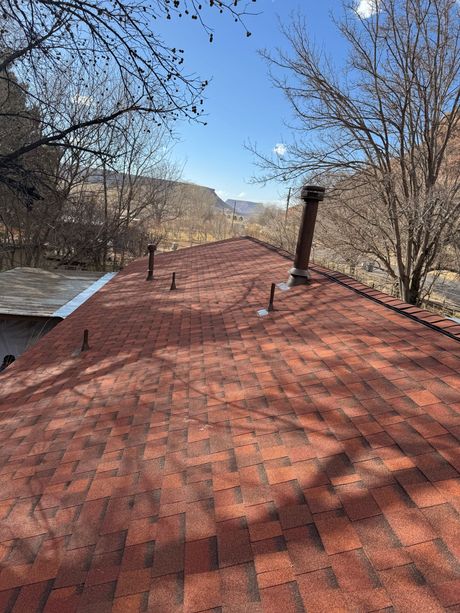 A red roof with a chimney on top of it.