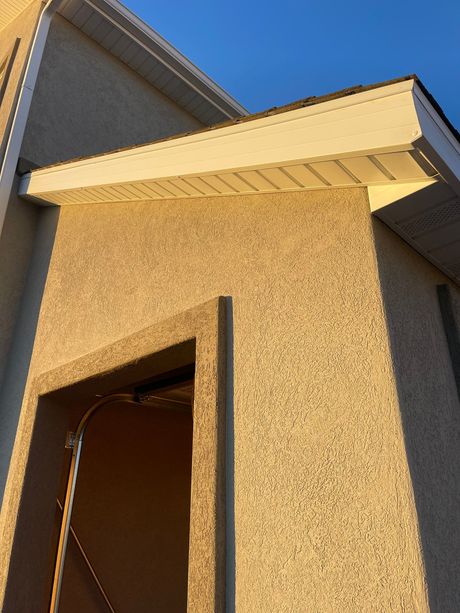 A building with a roof that has a white trim on it