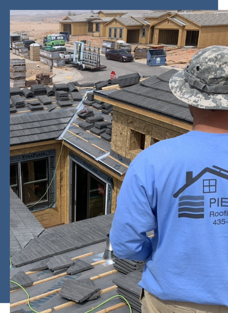 A man wearing a blue shirt that says pierce roofing and siding on it