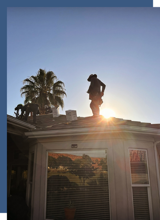 A man is standing on the roof of a house.