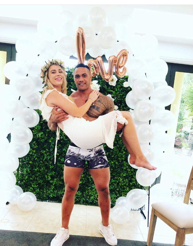 male holding a women in his arm