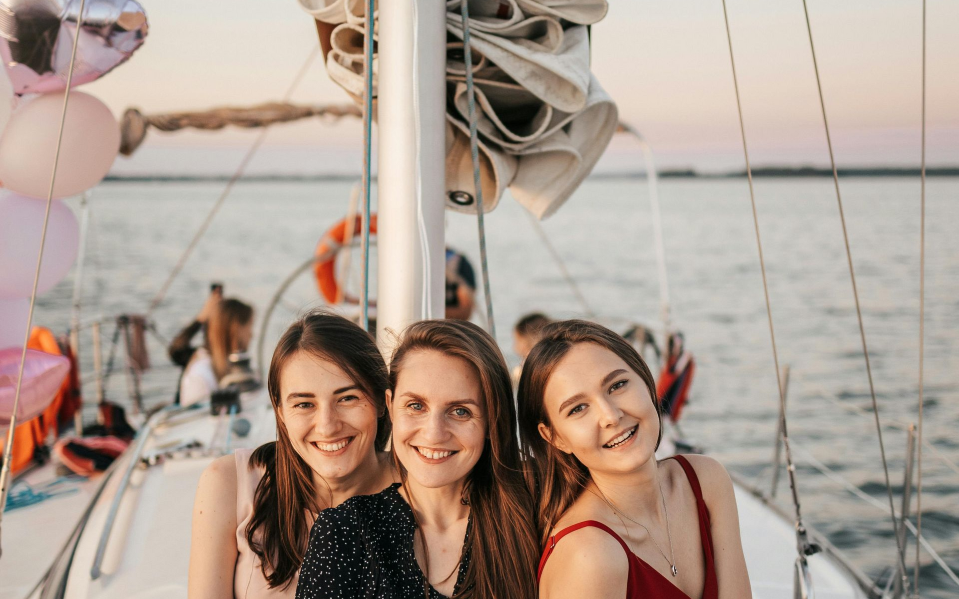 Girls smiling on a sailboat