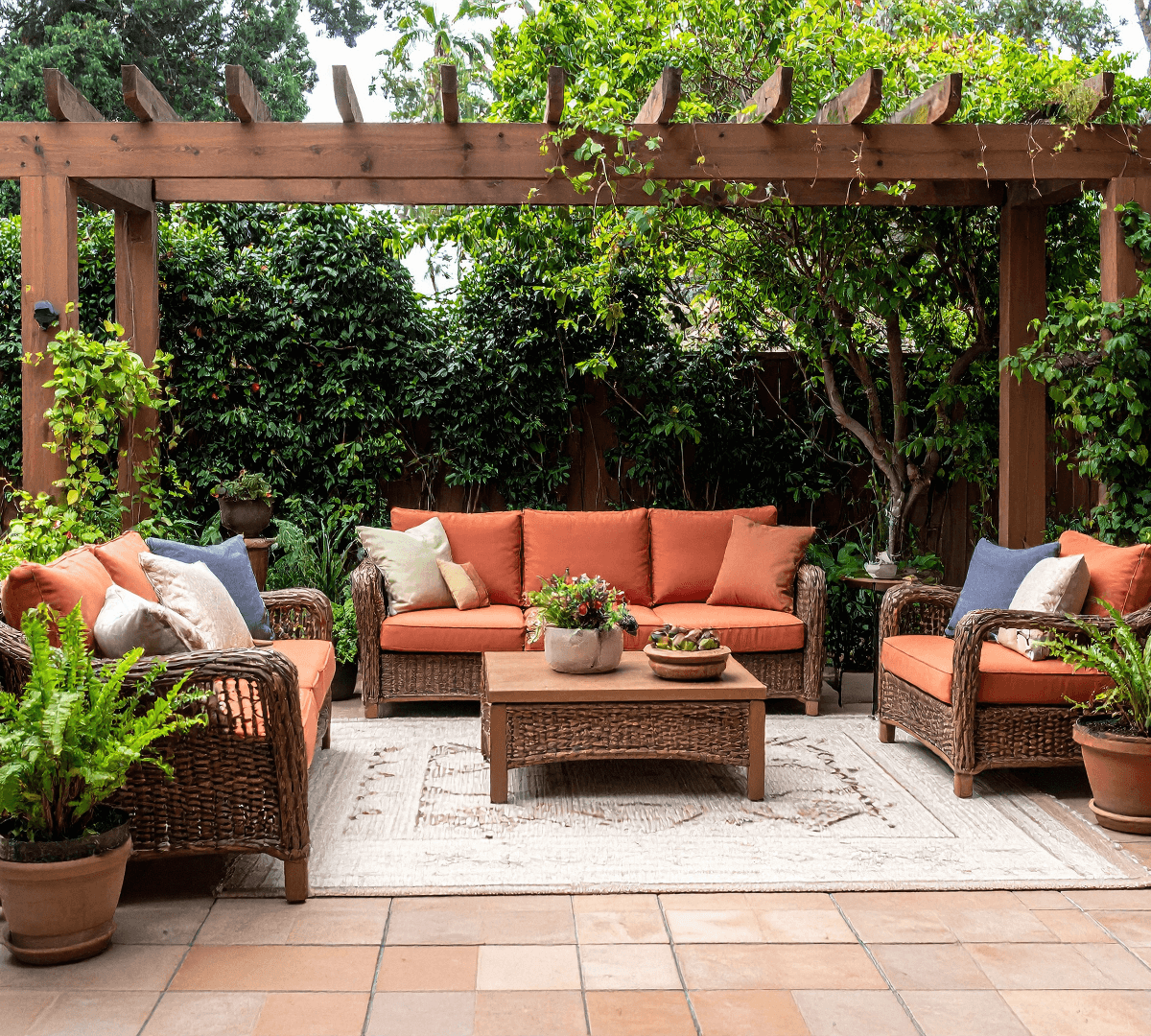 Man power washing a driveway, creating a light gray area on the dark asphalt.