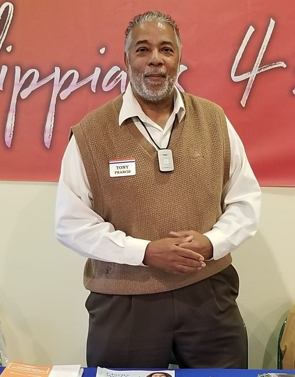 A man standing in front of a sign 