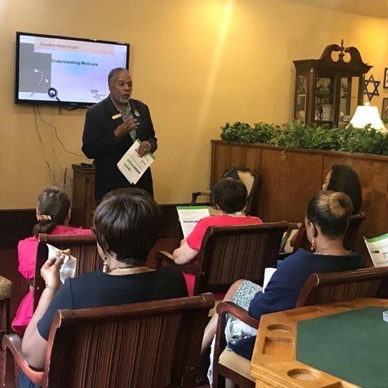 A man is giving a presentation to a group of people