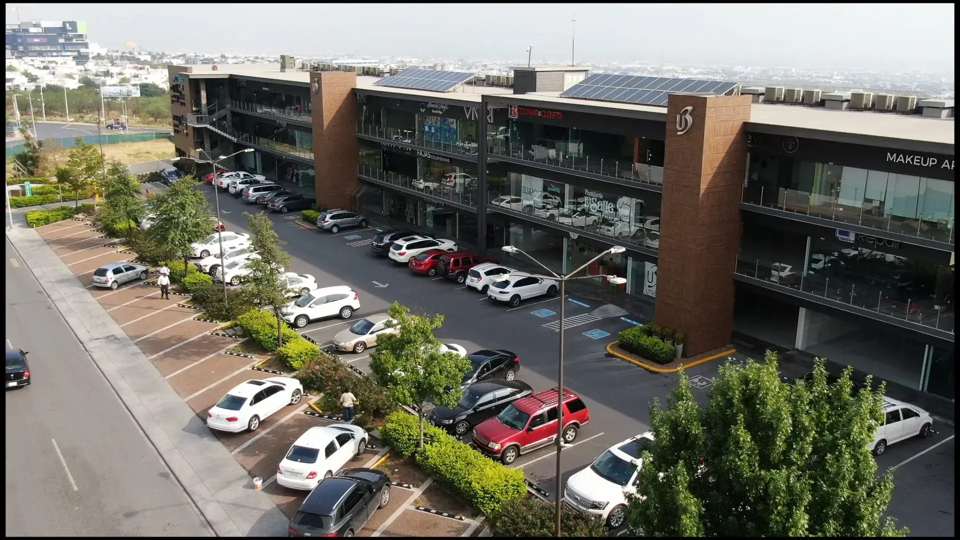 A brick building with a white door and flowers in front of it