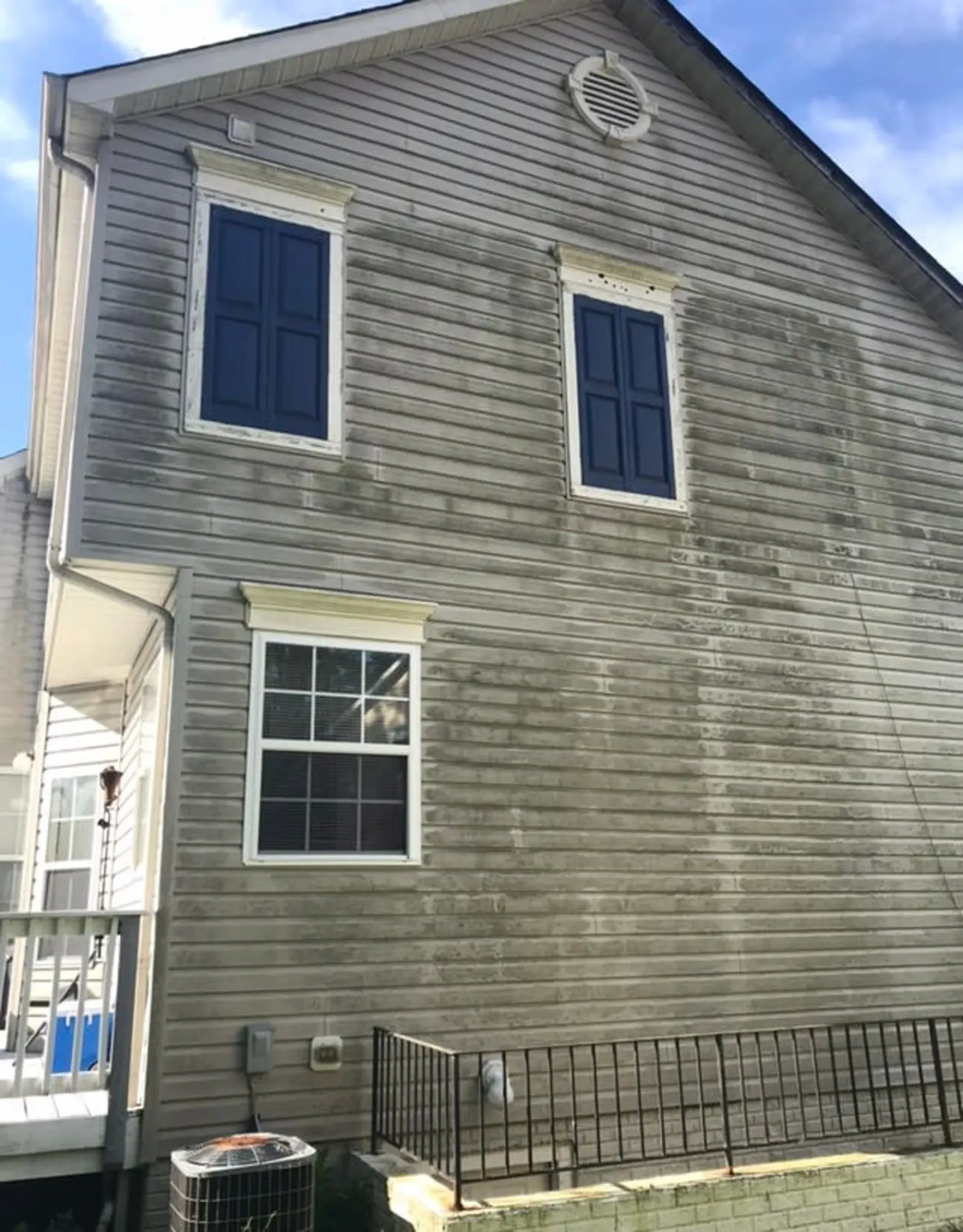 The side of a house with a lot of stains on it.