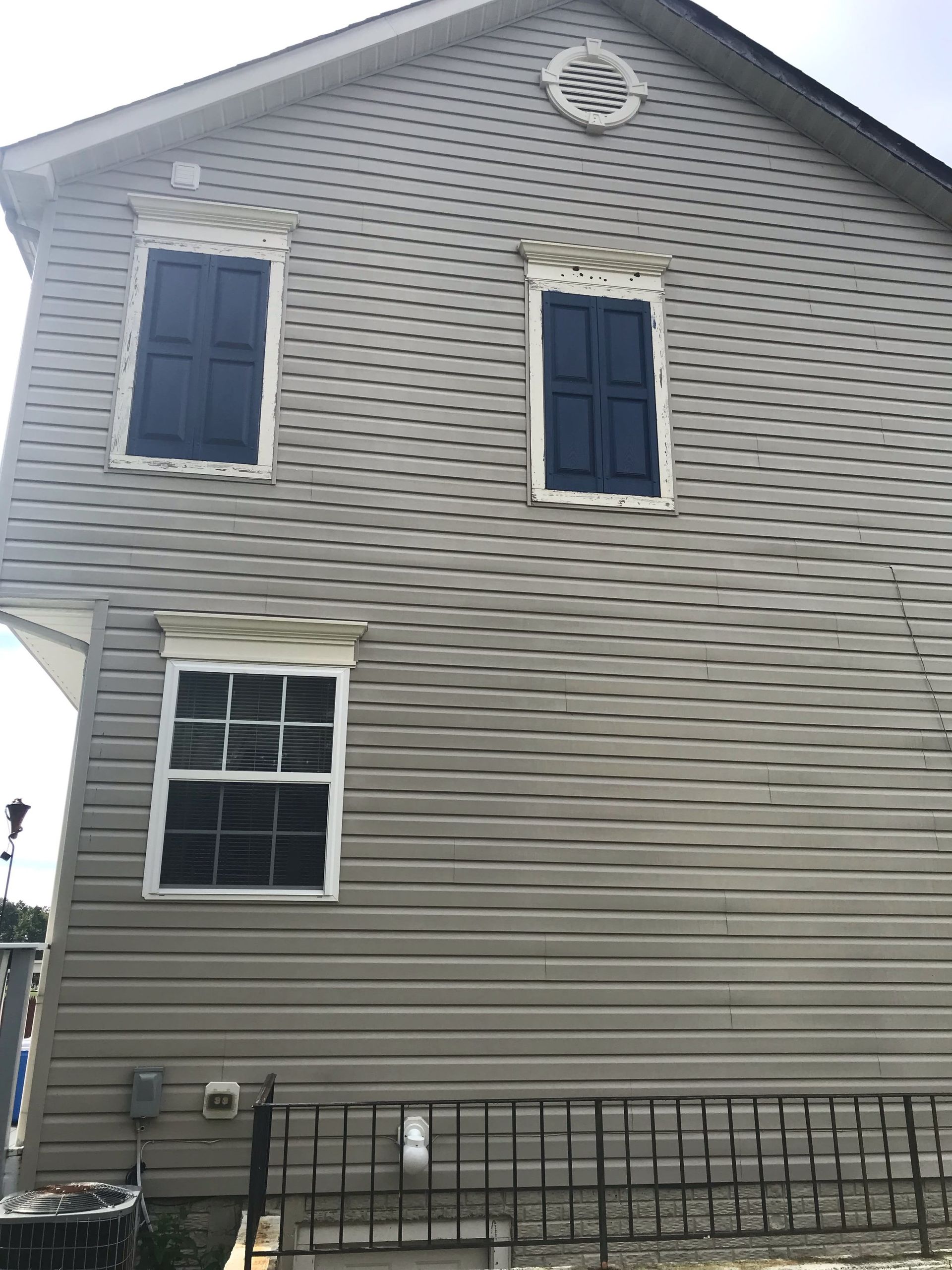 A house with a lot of windows on the side of it.