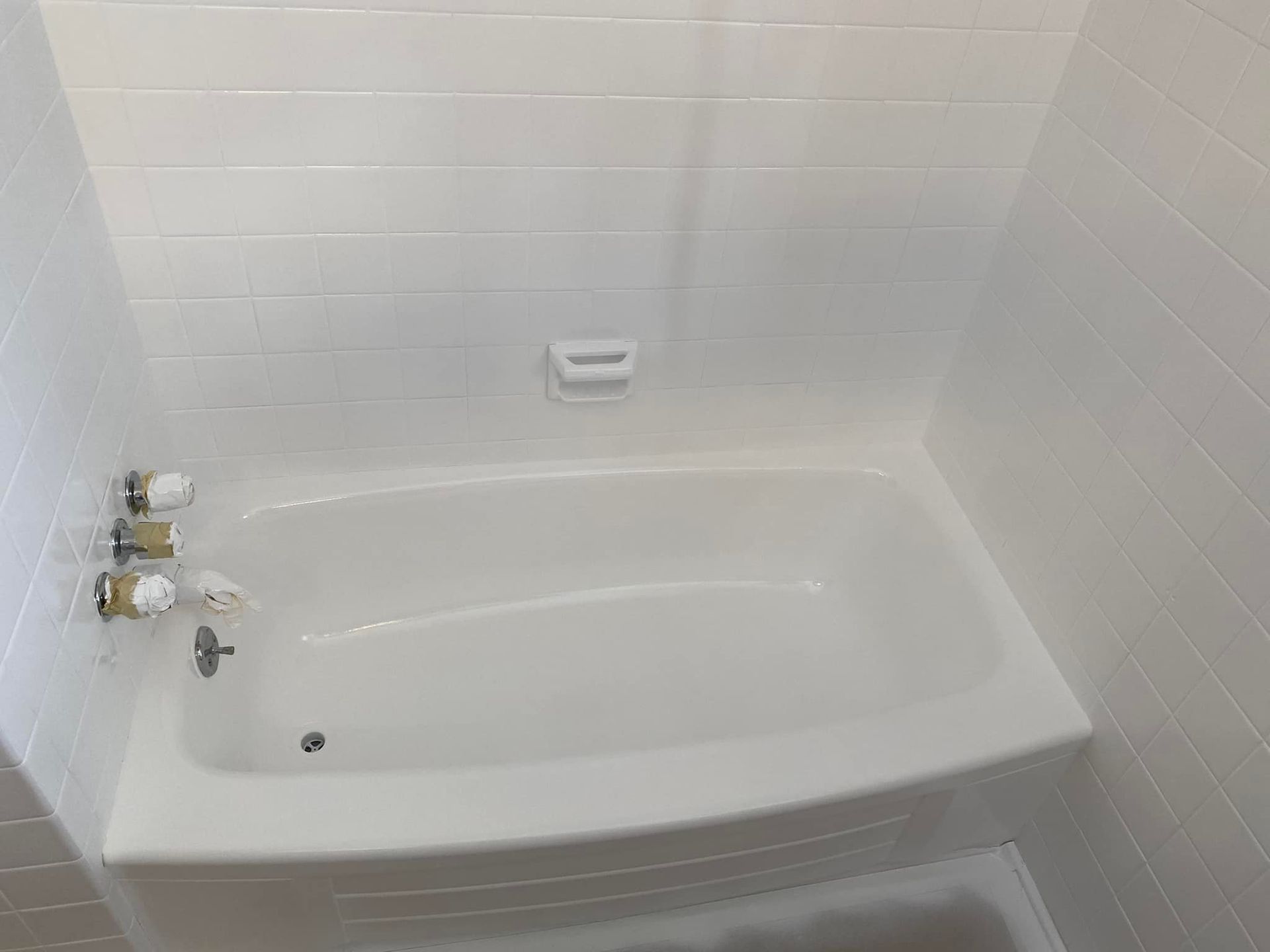 Image of a bathtub that just got refinished. You can see the new glaze is nice and clean. 