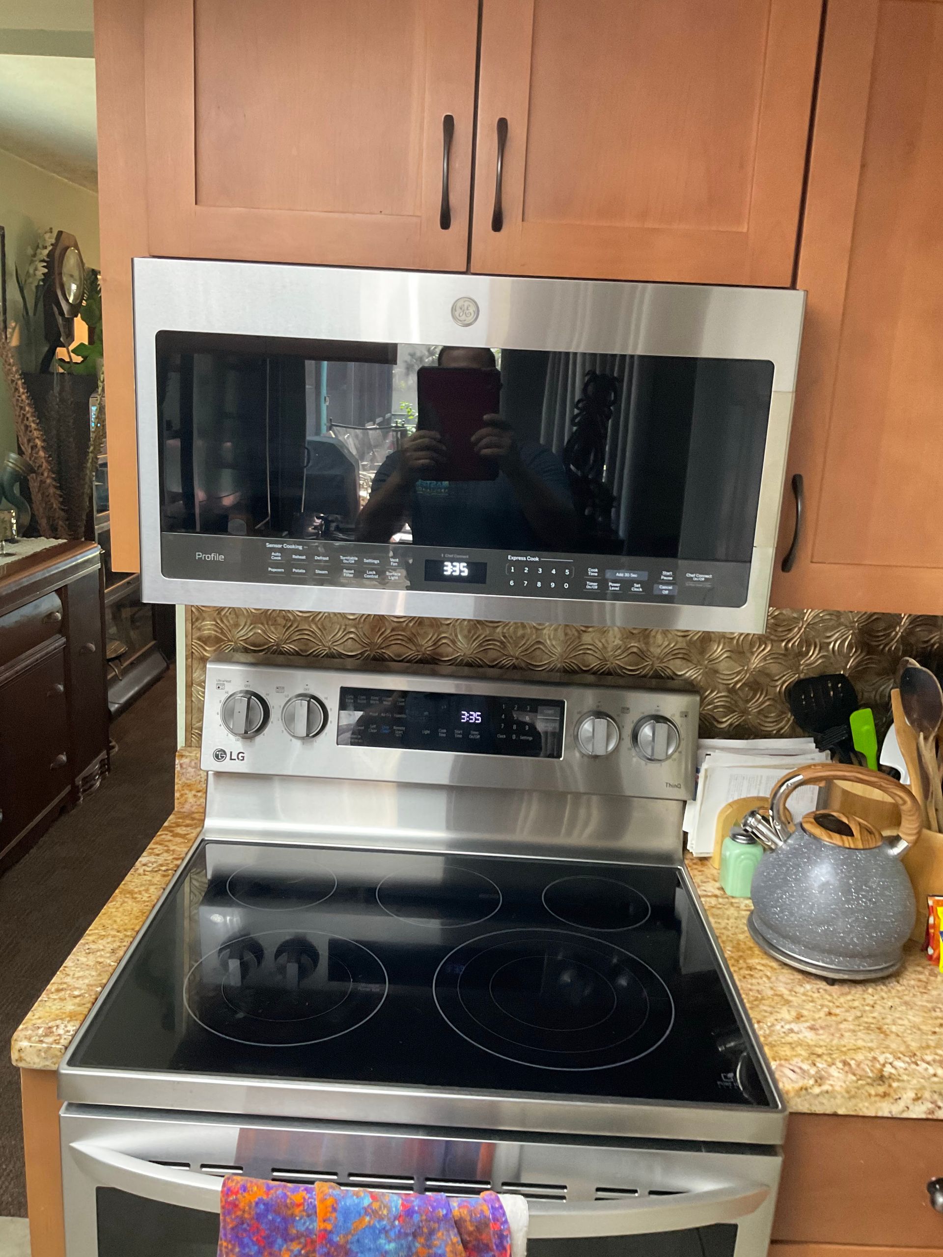 A stove with a microwave above it in a kitchen