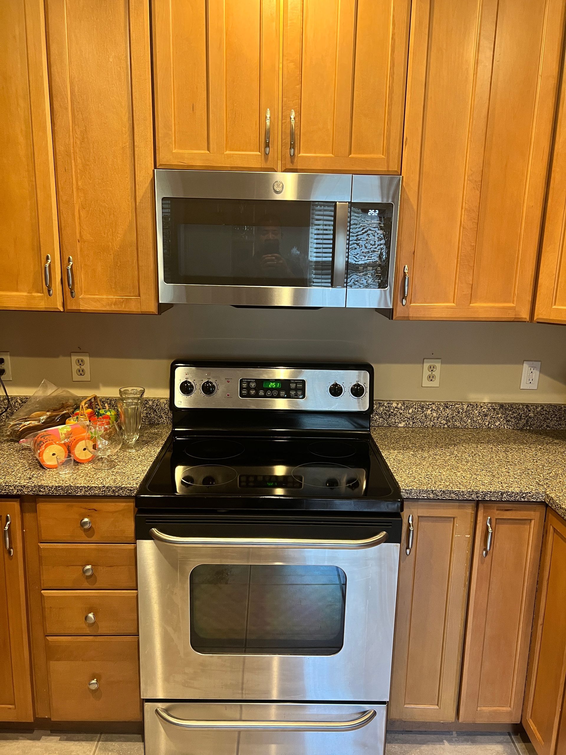 A kitchen with stainless steel appliances and wooden cabinets