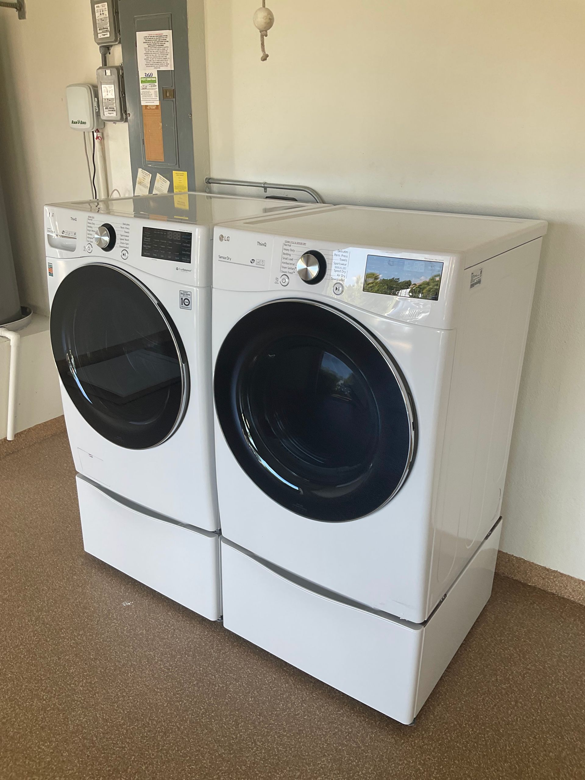 A washer and dryer are sitting next to each other in a laundry room.