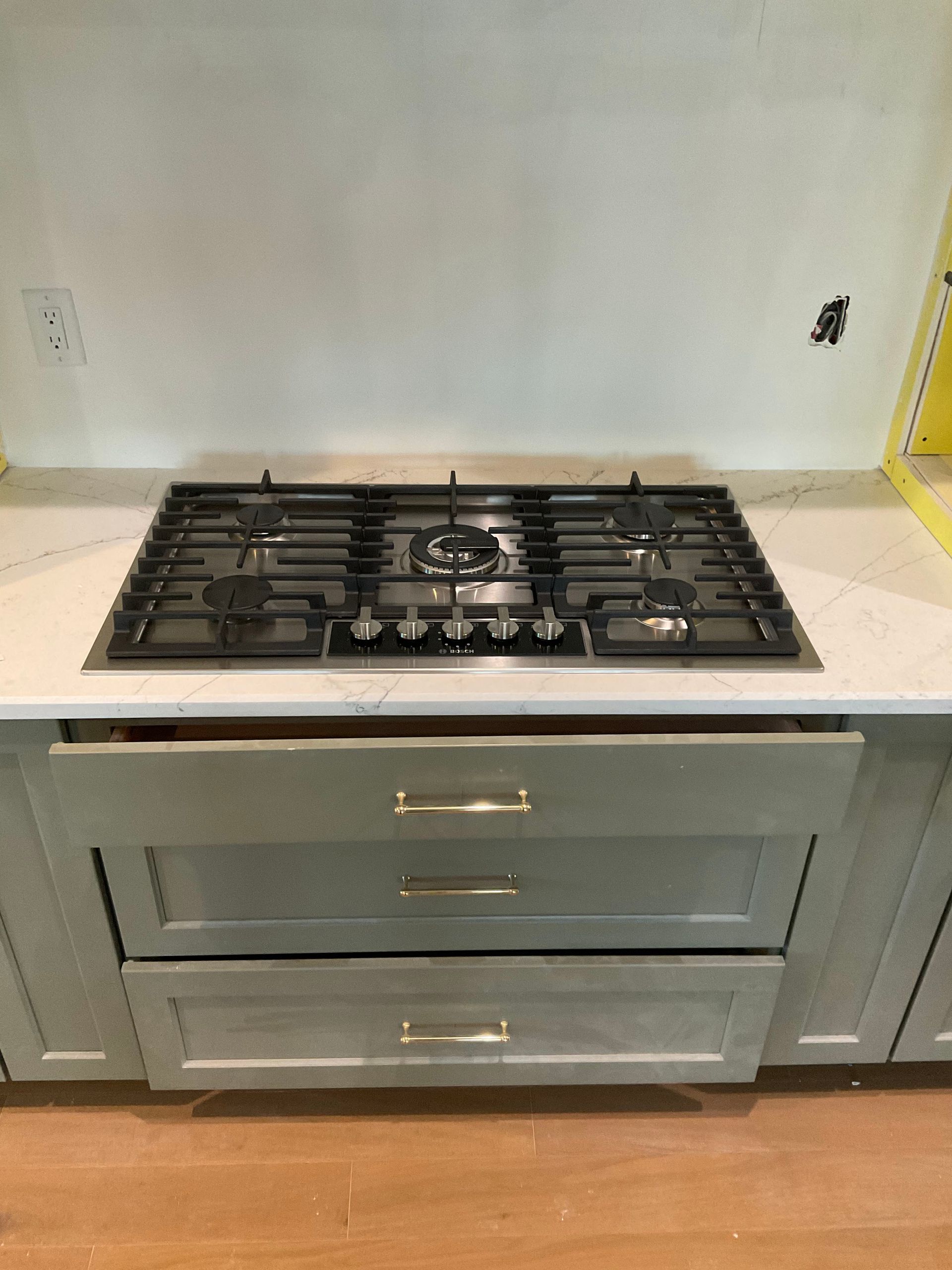 A stove top oven is sitting on top of a counter in a kitchen.