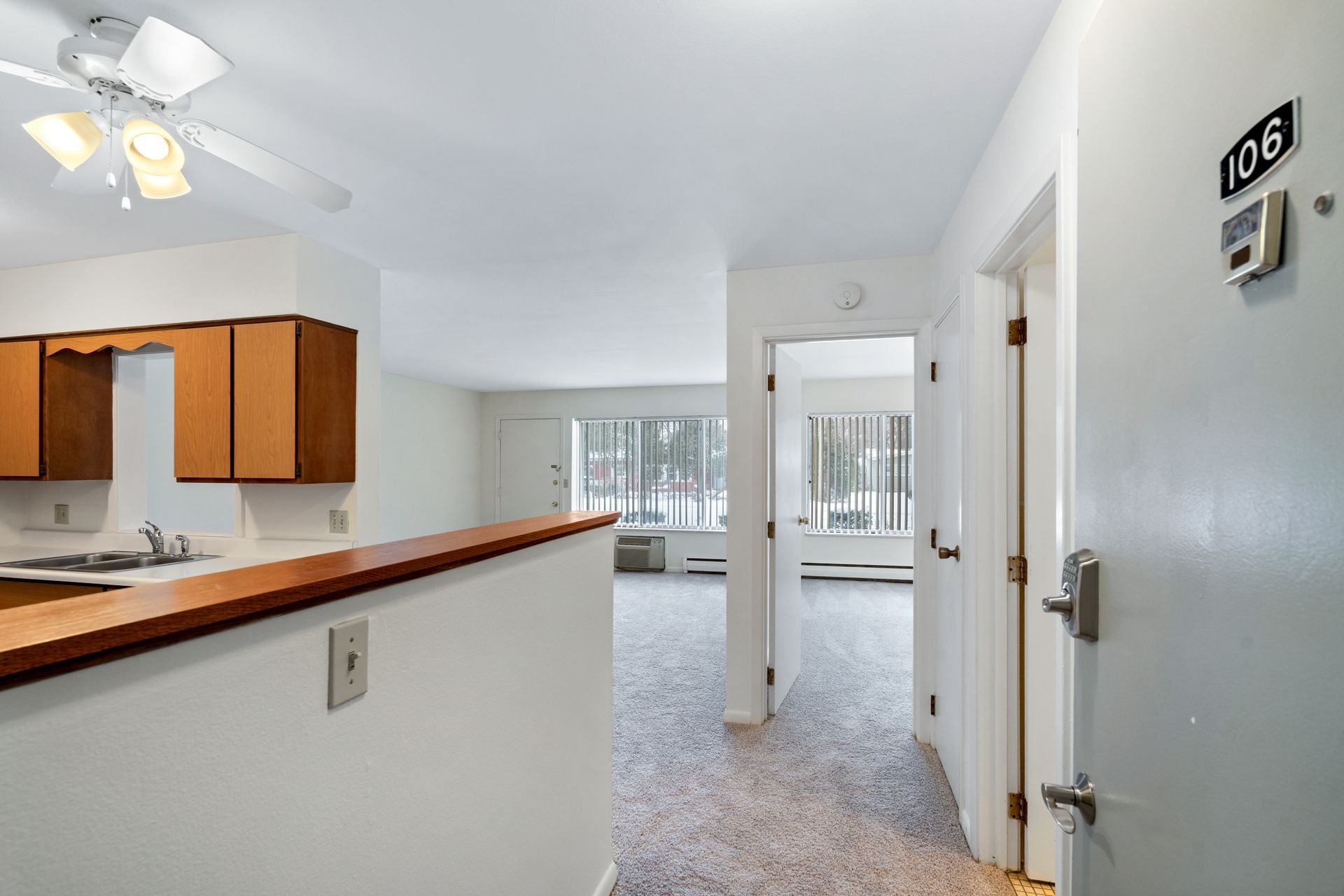 Photo of the entrance to a unit, with the kitchen to the left