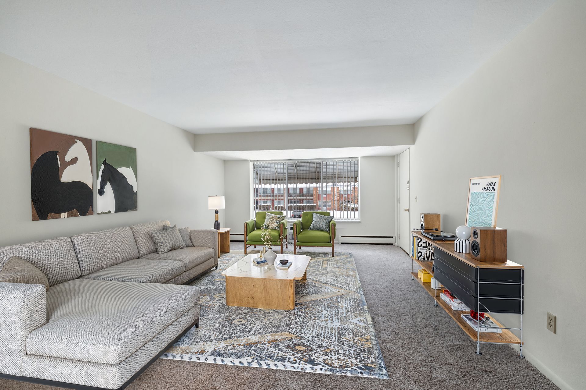 Photo of a large living room with a large couch and various furniture