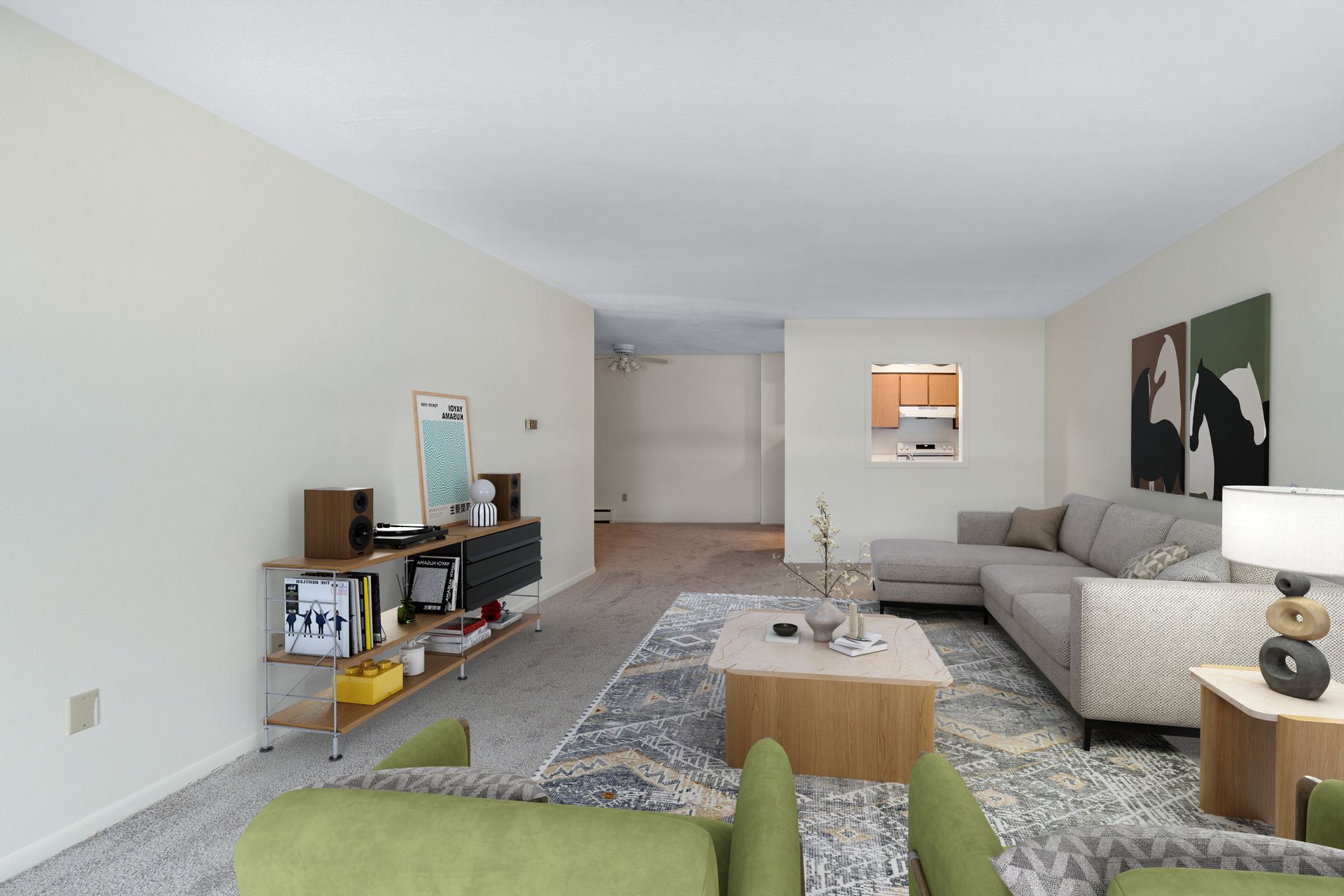 Photo of a large living room showing the entrance to the dining area in the background