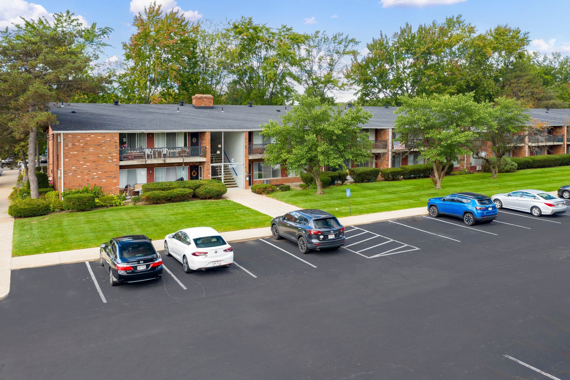 Photo of a parking lot out front of a two-story building