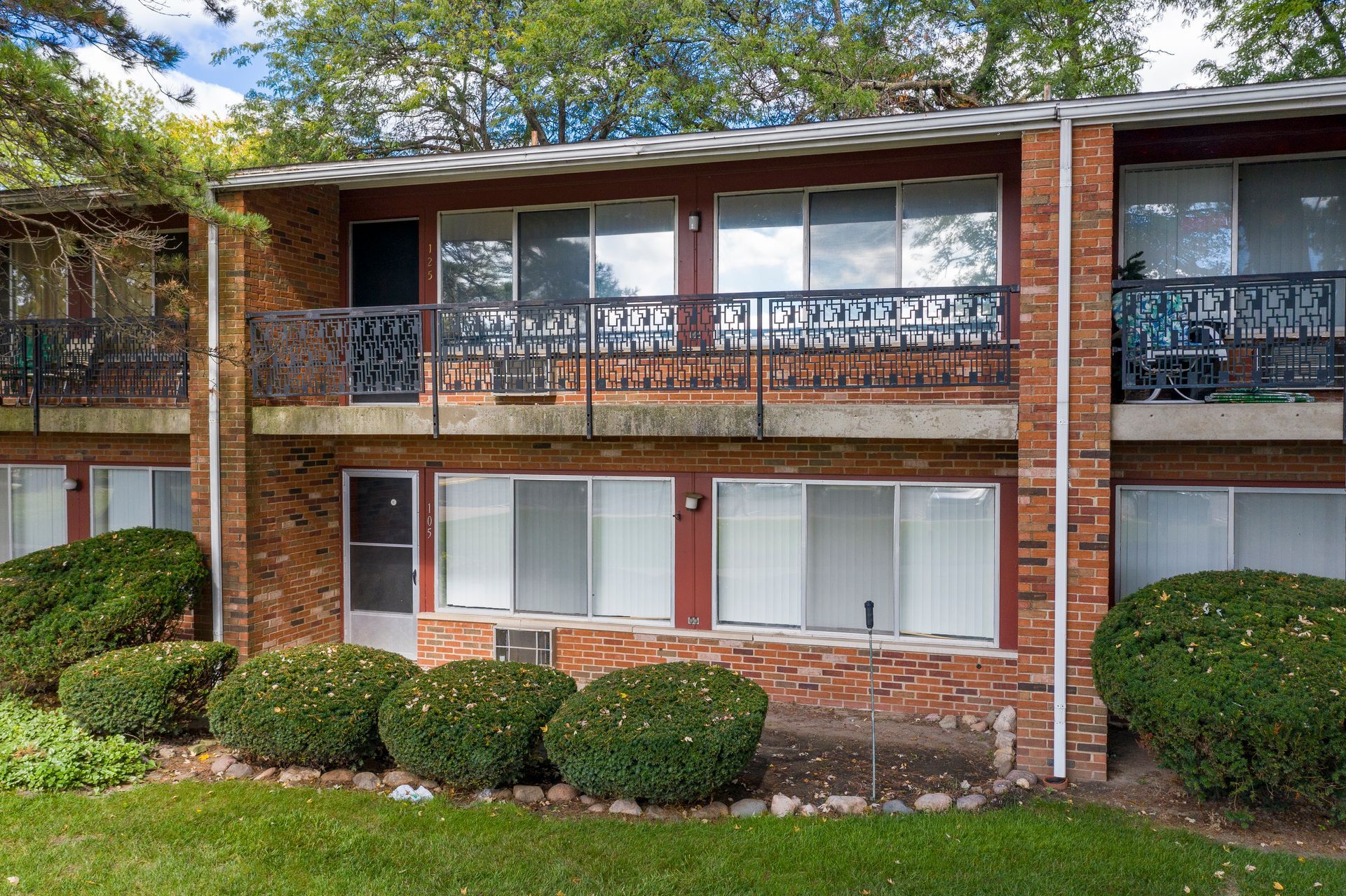 Photo of a two-story building  showing balconies on the top row