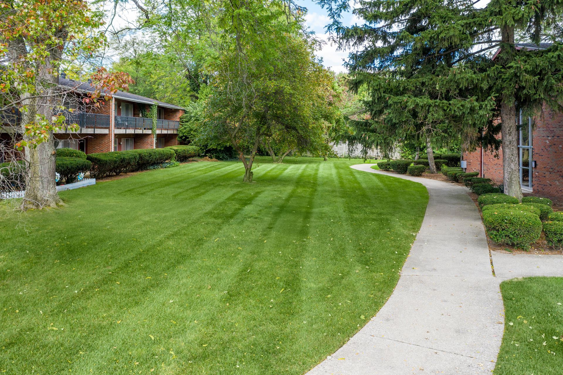 Photo of two story buildings with a large lawn in between them