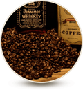 close up of coffee beans in front of whiskey bottle