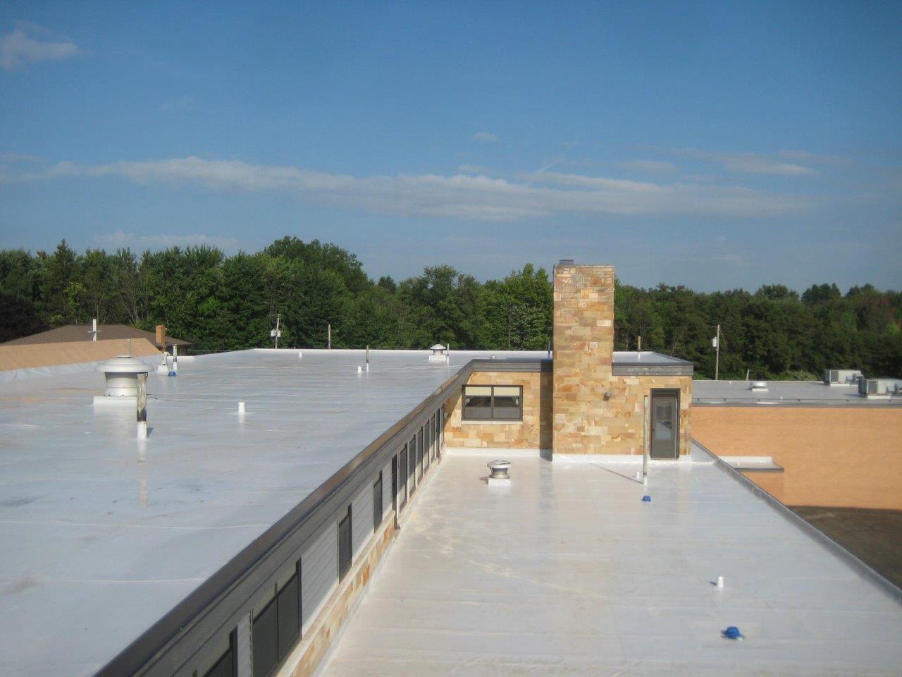 Worker Examines the Roof — Youngstown, OH — Holko Enercon Roofing Solutions