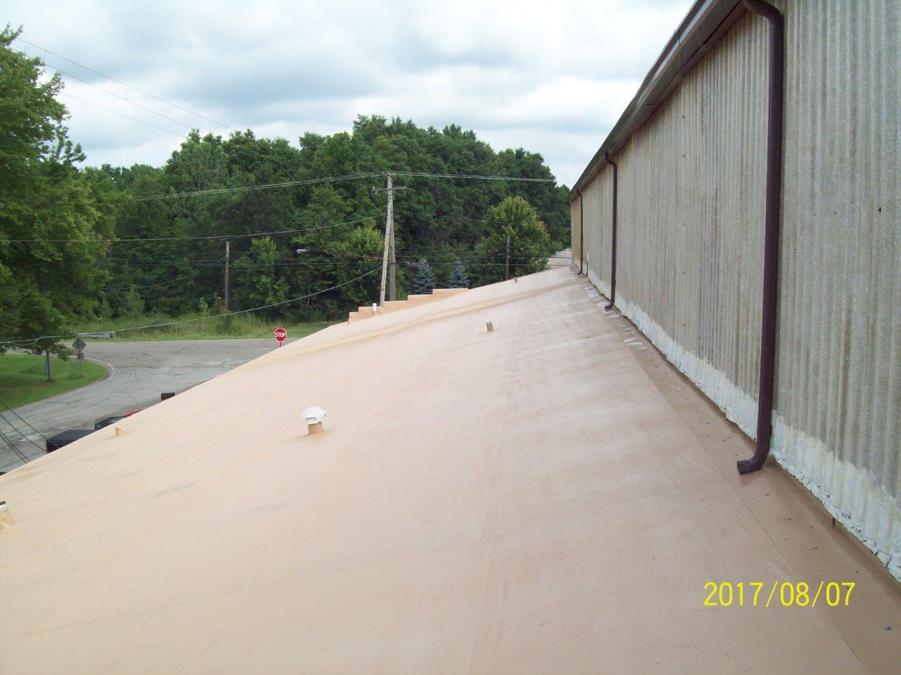 Worker Examines the Roof — Youngstown, OH — Holko Enercon Roofing Solutions