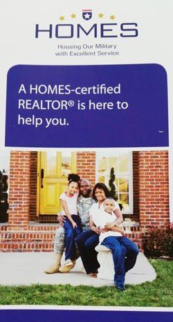 A photo of a military family in front of a house and the words 