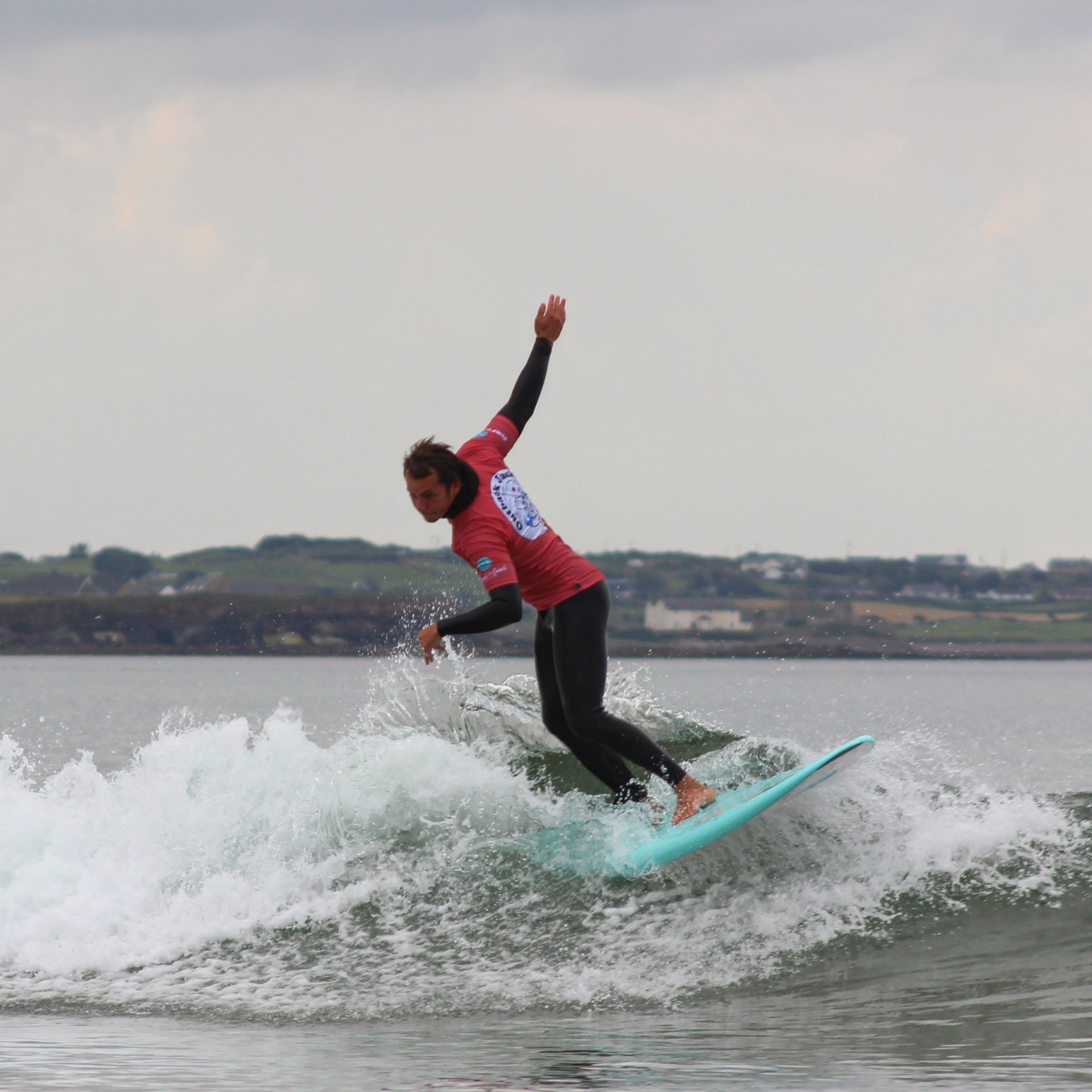 A man is riding a wave on a surfboard in the ocean