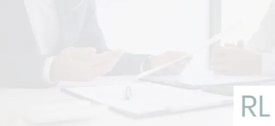 A man is sitting at a desk using a tablet computer.