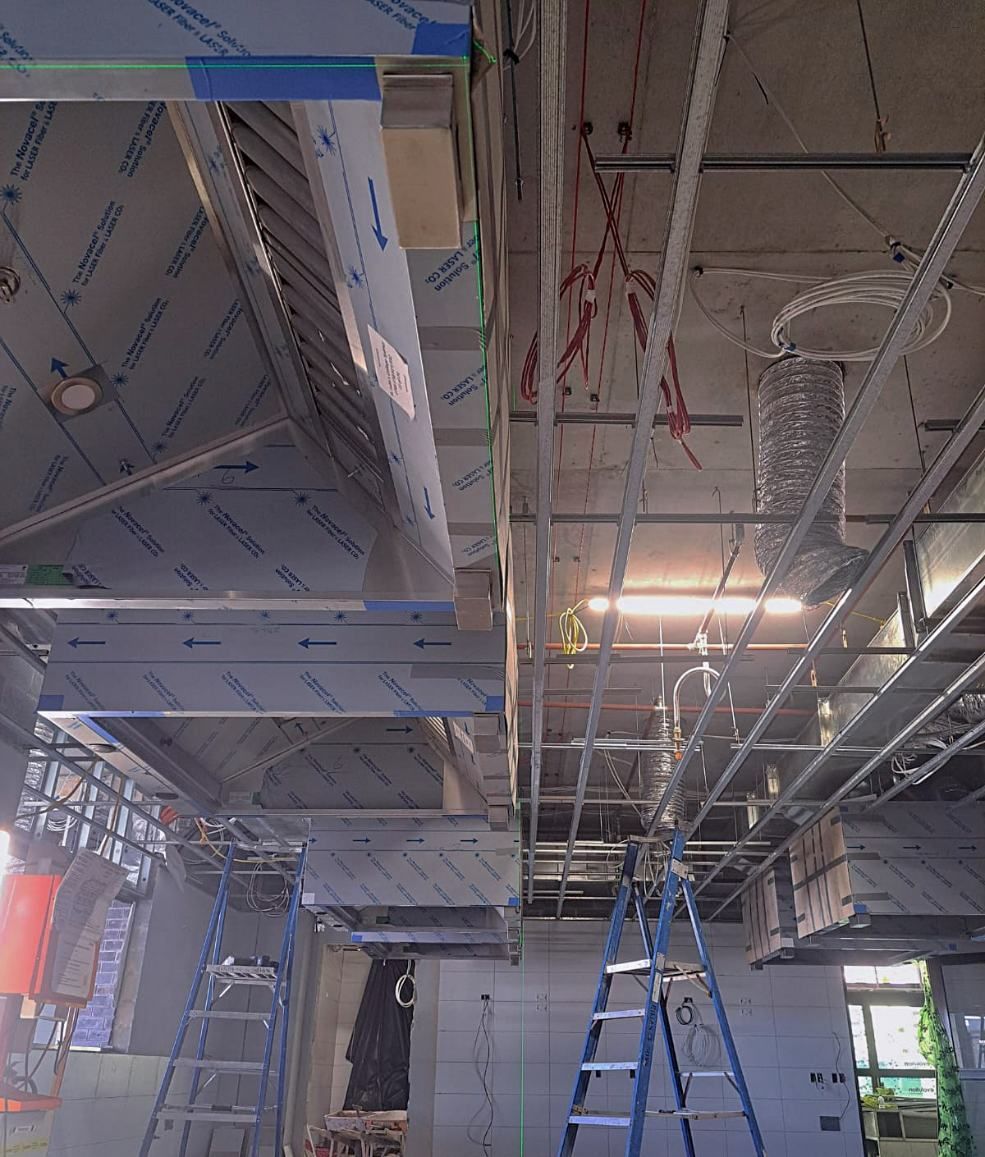 A Room With a Lot of Pipes Hanging From the Ceiling — Accurate Fitout Solutions In Wetherill Park, NSW