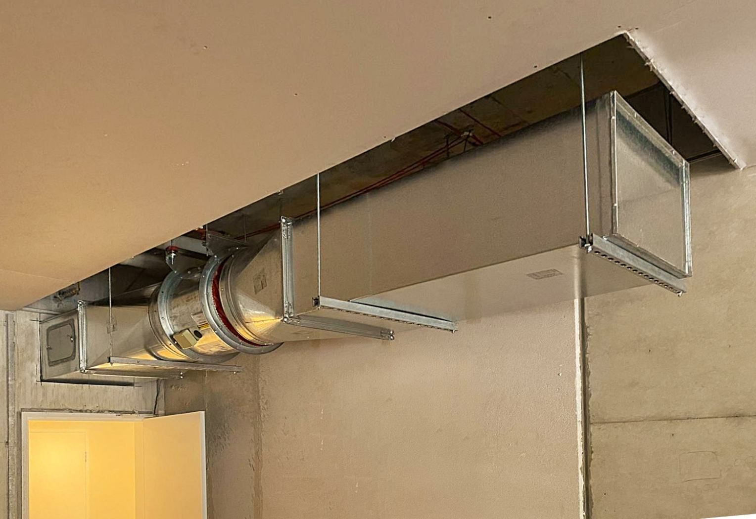 A Row of Metal Pipes Hanging From the Ceiling of a Room — Accurate Fitout Solutions In Sydney, NSW