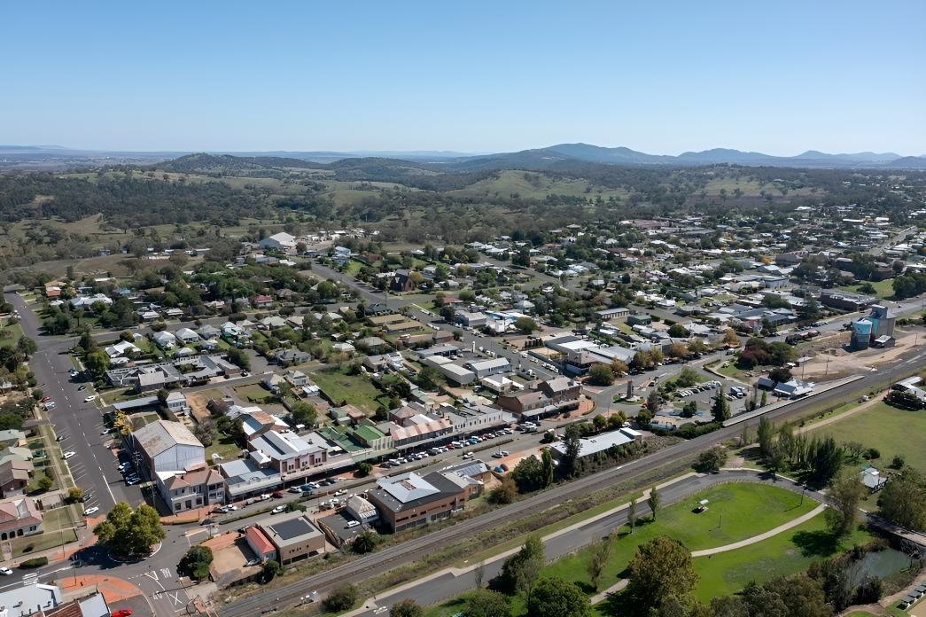 An Aerial View of a Small Town With Mountains in the Background — Accurate Fitout Solutions In Mascot, NSW