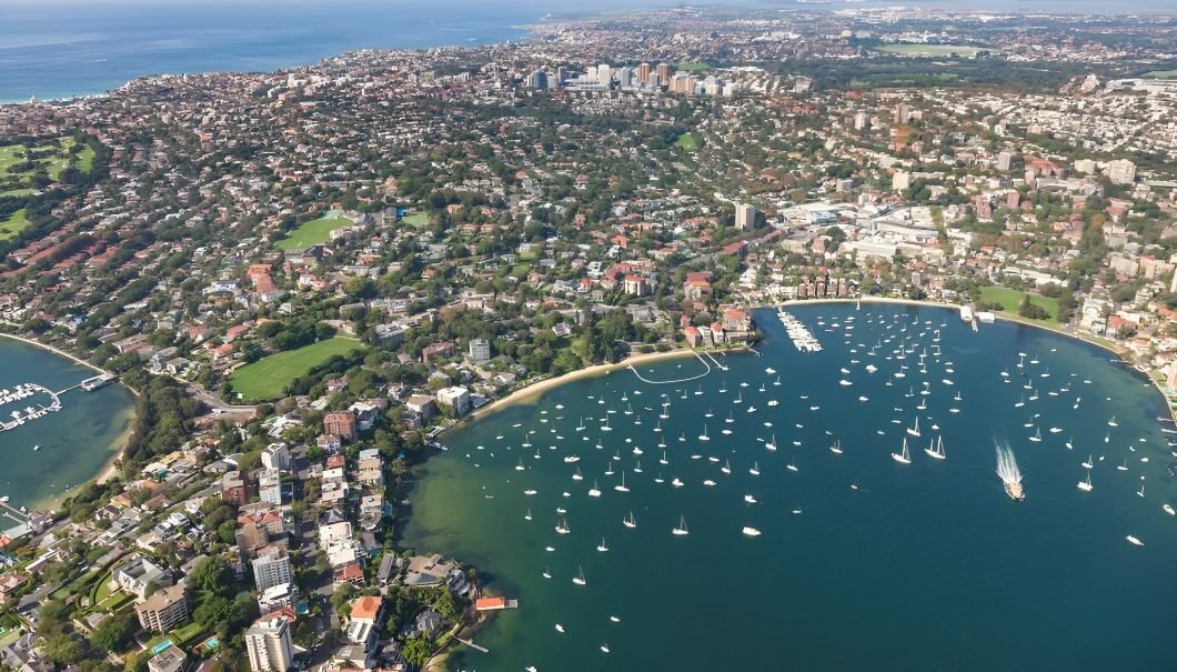 An Aerial View of a Large Body of Water Surrounded by a City — Accurate Fitout Solutions In Alexandria, NSW