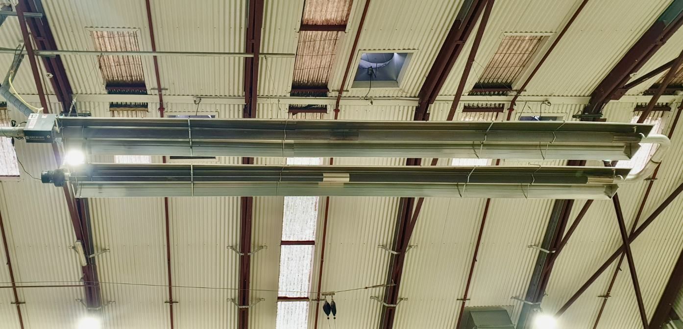 A Large Heater is Hanging From the Ceiling of a Building — Accurate Fitout Solutions In Auburn, NSW