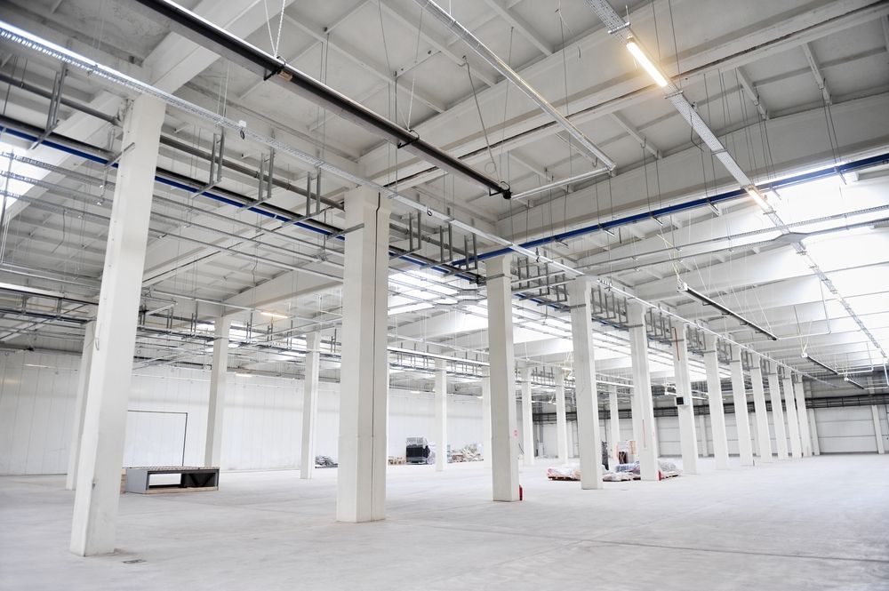 A Large Empty Warehouse With a Lot of Columns — Accurate Fitout Solutions In Eastern Creek, NSW