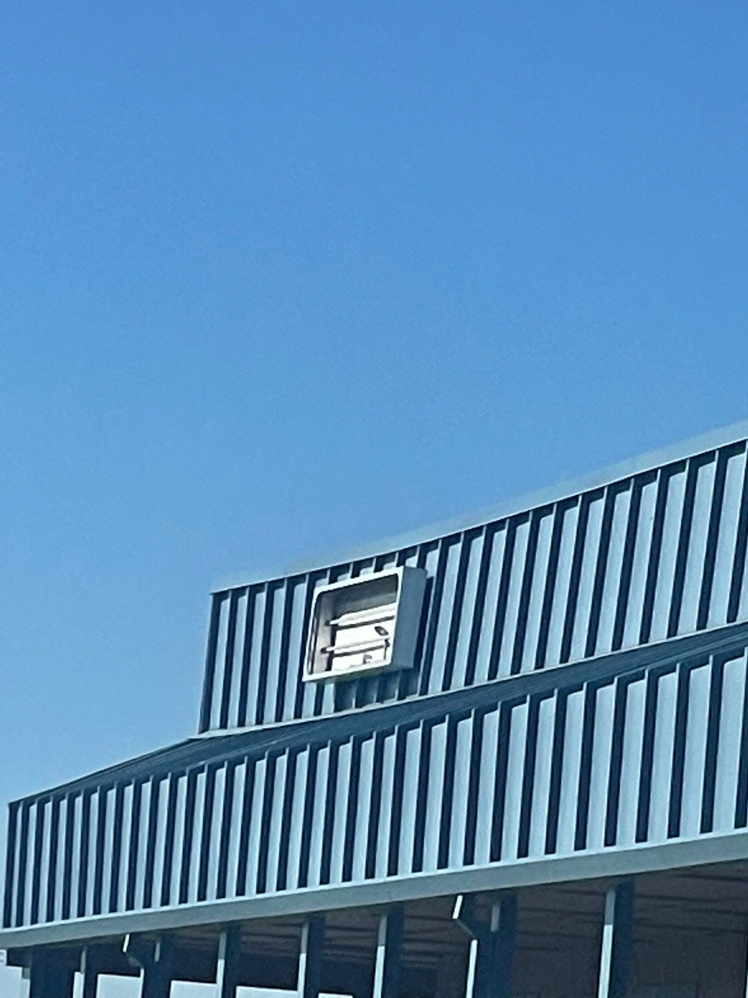 A large building with a blue sky in the background