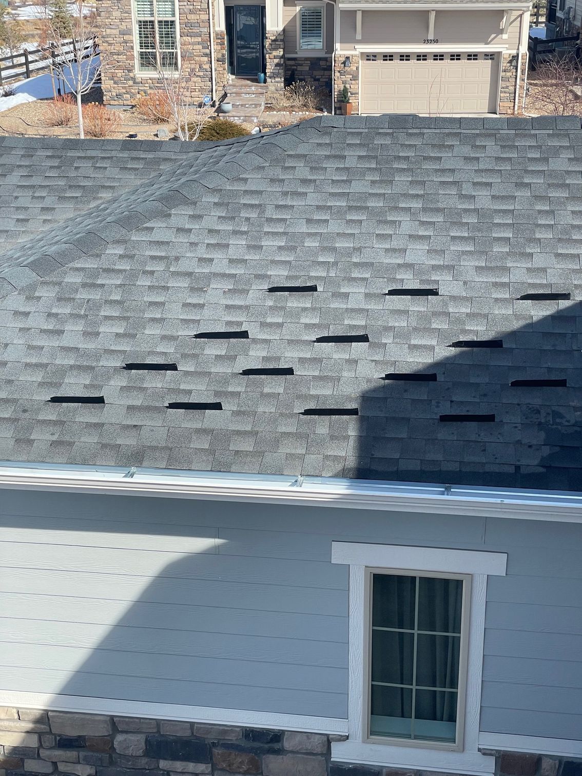A house with a roof that has a lot of shingles on it.
