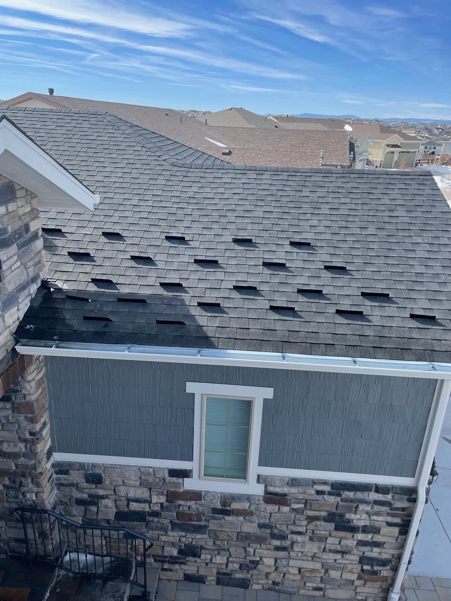 A house with a roof that has a lot of shingles on it.