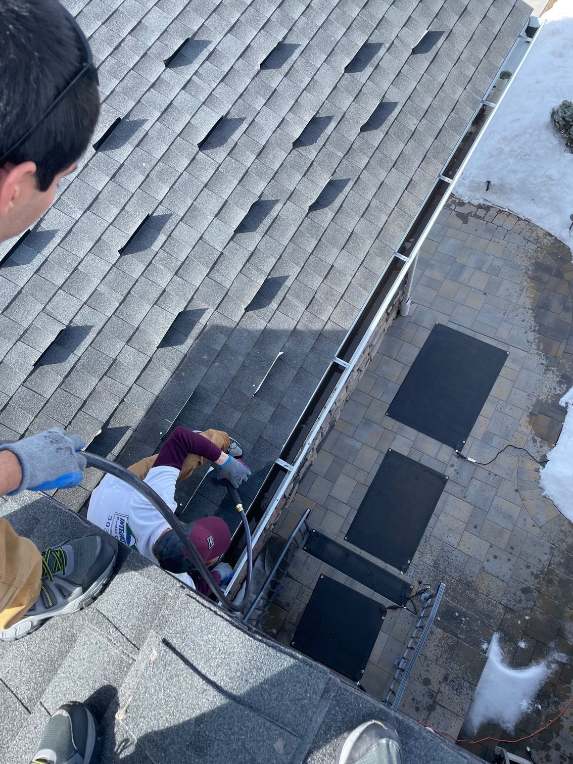 A group of people are working on a roof.