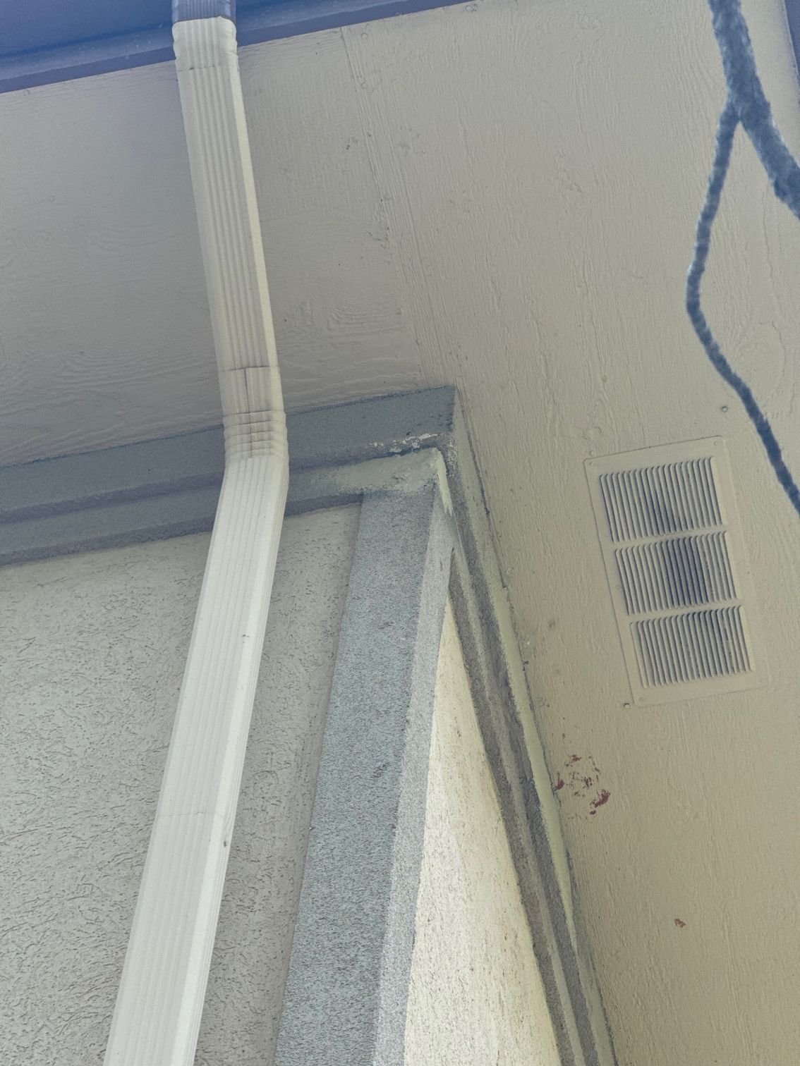 A close up of a wall with a drain on it