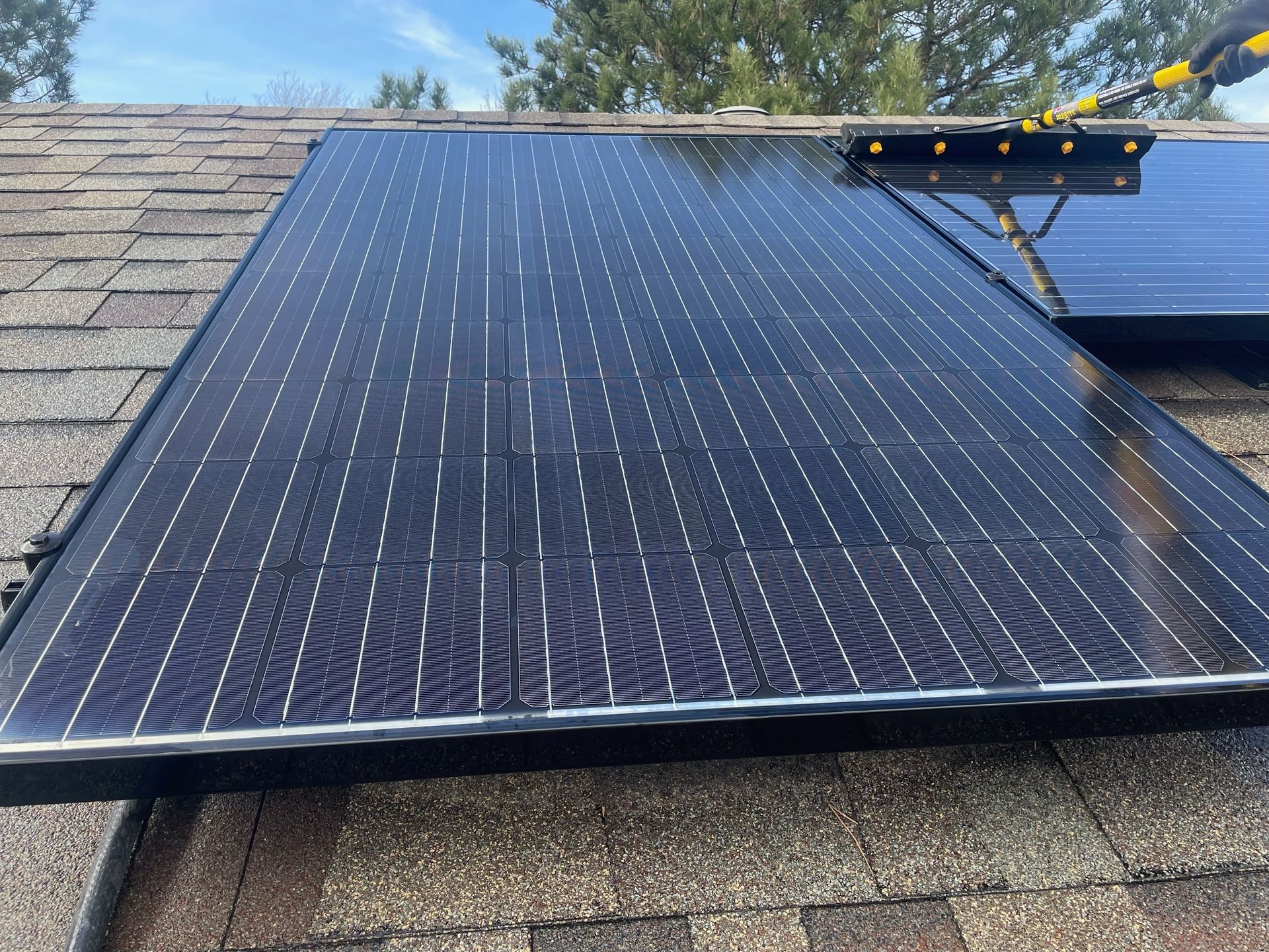 A solar panel is sitting on top of a roof.