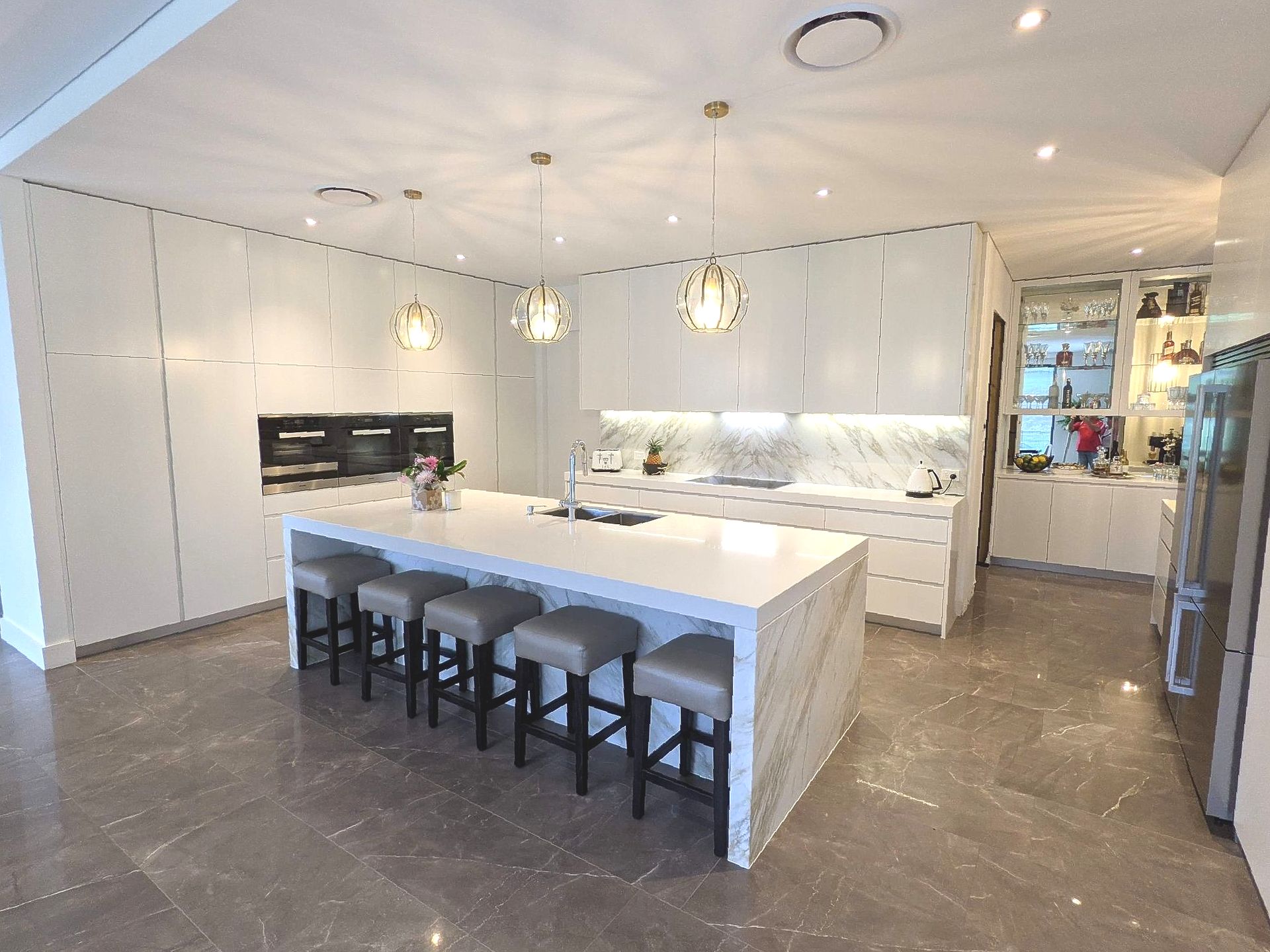 A modern kitchen with handing lights — The Right Kitchen Company in Shellharbour, NSW