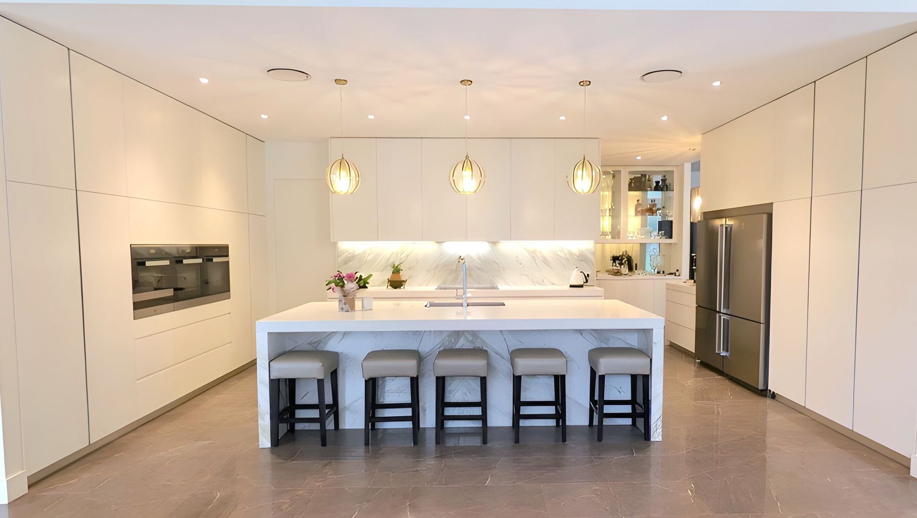 Kitchen with bar stools next to an island bench — The Right Kitchen Company In Berkeley, NSW