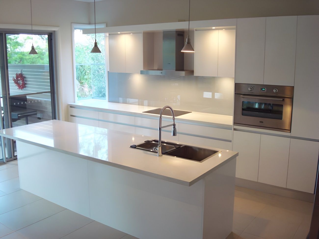 A Kitchen Counter With Green Cabinets And A White Counter Top — The Right Kitchen Company In Berkeley, NSW