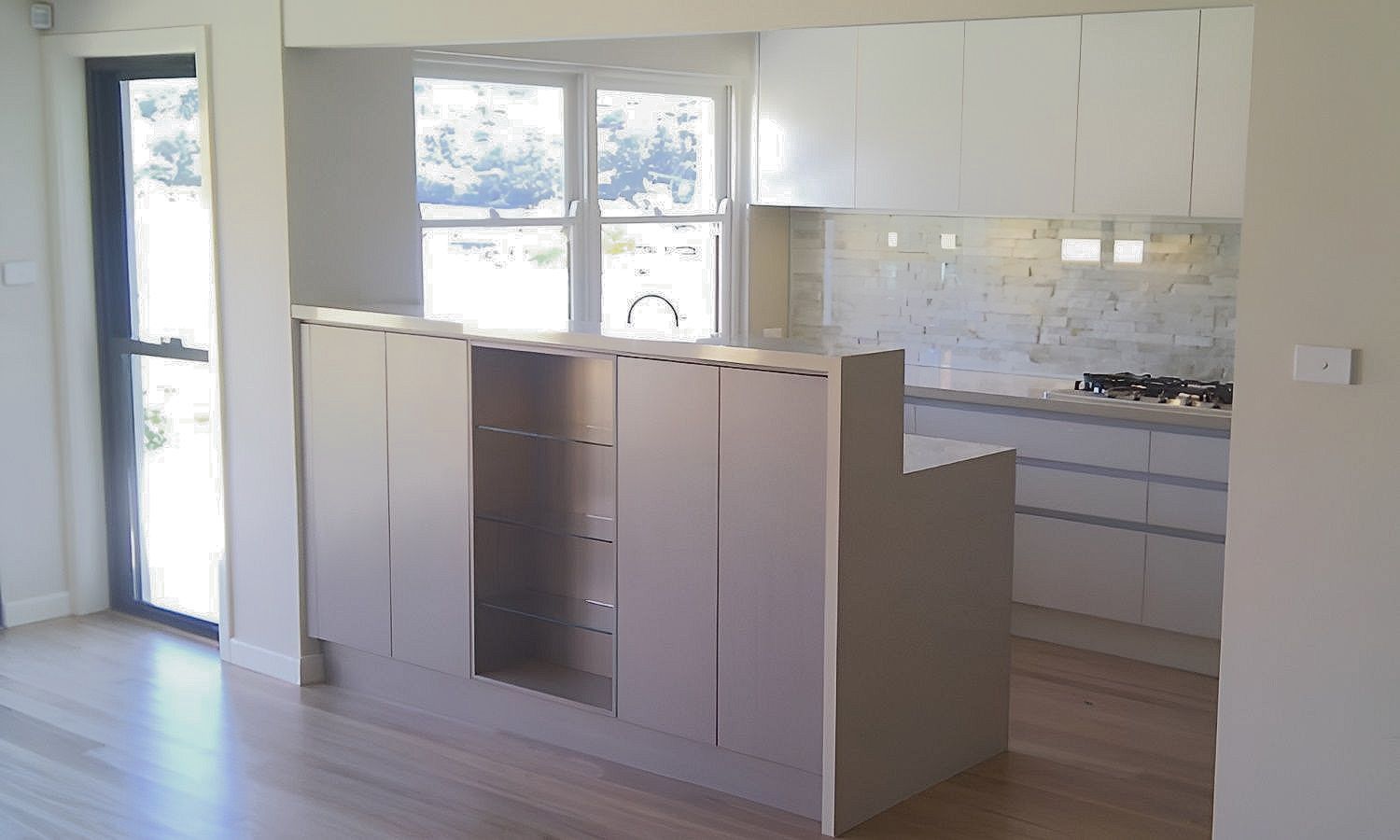 A Kitchen With White Cabinets And A Wooden Floor — The Right Kitchen Company In Berkeley, NSW